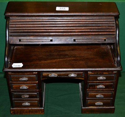 Lot 372 - A miniature 1920s style roll top desk