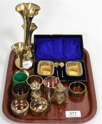 Lot 377 - Three graduated silver posy vases; a pair of cased salts with spoons; various napkin rings; peppers