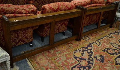 Lot 1148 - Yorkshire School: a pair of English oak kneeling benches, each with shaped ends, the sloping...