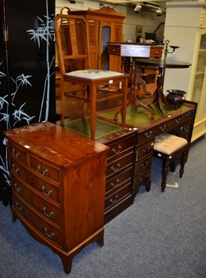 Lot 1166 - A reproduction pedestal writing desk; a writing table/stationary cabinet; a reproduction bow...