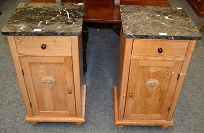 Lot 1174 - A pair of pine bedside pot cupboards with marble tops