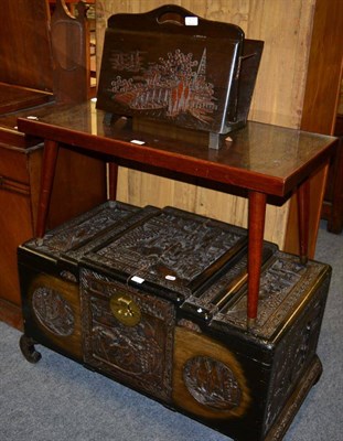 Lot 1176 - A carved Chinese camphor wood chest, carved Chinese coffee table and similar magazine rack (3)