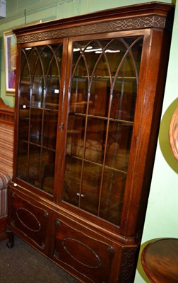 Lot 1198 - A mahogany glazed bookcase on stand