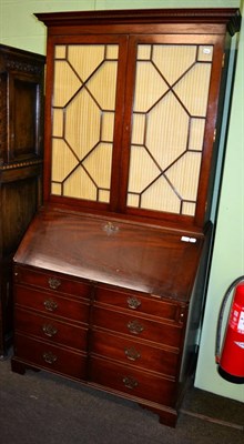 Lot 1202 - A reproduction mahogany bureau bookcase