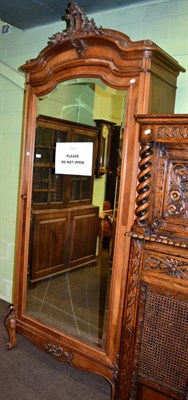 Lot 1204 - A French walnut veneered armoire with central bevelled glazed panel