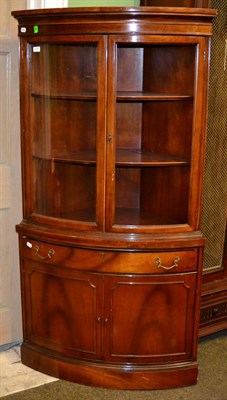 Lot 1210 - A bow fronted standing corner cupboard