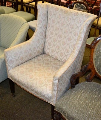 Lot 1249 - An Edwardian upholstered wing armchair