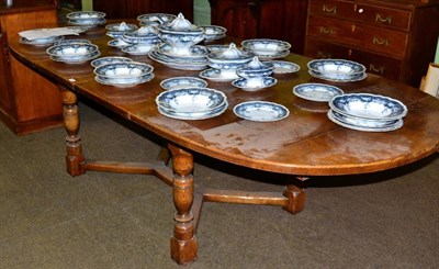 Lot 1252 - A reproduction oak extending dining table