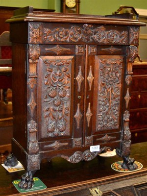 Lot 1283 - A Victorian ornately carved cabinet fitted with drawers and a recess