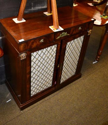 Lot 1287 - A pair of Regency style mahogany brass grill door cabinets