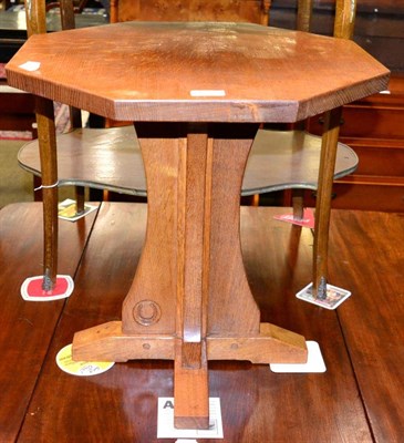 Lot 1288 - Horseshoeman: an English oak octagonal coffee table, on a cruciform base, with recessed carved...