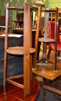 Lot 1296 - A pair of early 20th century oak two-tier stands, tri-supports and stretchers, 100cm high (2)