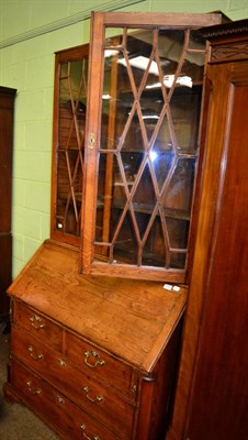 Lot 1304 - A George III style oak bureau bookcase