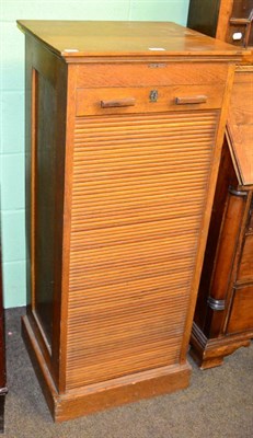 Lot 1305 - A light oak stationary cabinet with sliding front and applied plaque stamped 'Boots Business...