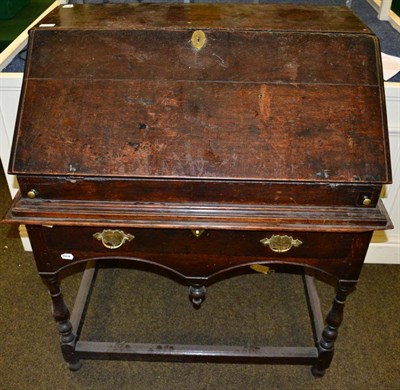 Lot 1325 - An 18th century and later oak bureau on stand