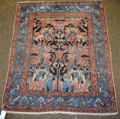 Lot 1331 - Hamadan rug, Iranian Kurdistan, the indigo field of stylised flowers enclosed by triple...