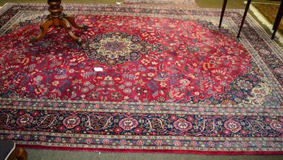 Lot 1335 - Kashan Carpet, Central Iran, the raspberry field of stylised plants around an indigo pole medallion