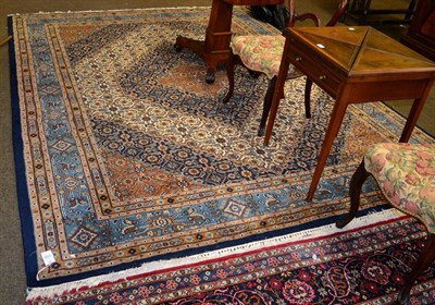 Lot 1336 - An Indian carpet, the stepped ivory Herati field with indigo medallion enclosed by samovar borders