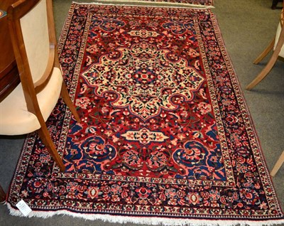 Lot 1341 - Bakhtiari Rug, West Iran, the blood red field with ivory medallion framed by spandrels and...