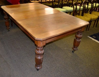 Lot 1345 - A late Victorian oak wind out dining table