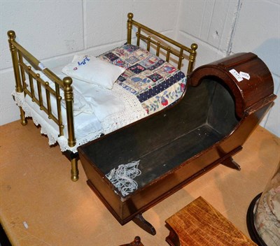 Lot 1372 - Mahogany dolls cradle and a dolls brass bedstead with bedding (2)