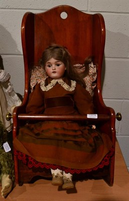 Lot 1374 - Victorian mahogany dolls rocking chair and a German bisque socket head doll (a.f.)