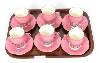 Lot 3 - A set of six silver coffee cup holders, Elkington & Co, Birmingham, with Coalport pink ground...