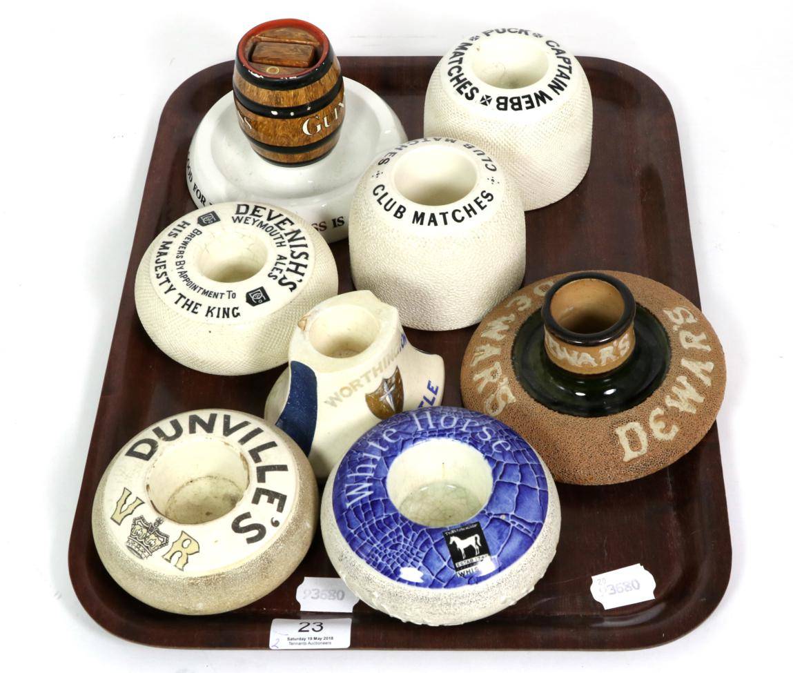 Lot 23 - Two trays of advertising match strikers and holders including Guinness, Dewar's, White Horse...