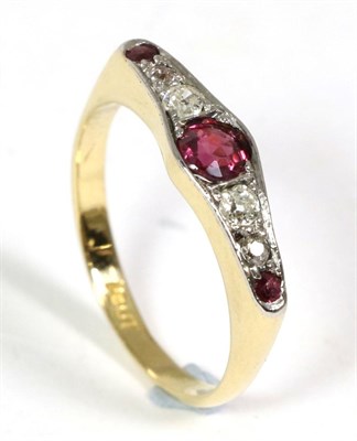 Lot 44 - An early twentieth century ruby and diamond ring, a round cut ruby spaced by four graduated old cut