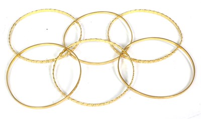 Lot 49 - A set of six Asian bangles, with two faceted designs, measure 6.5cm in diameter, 5mm wide