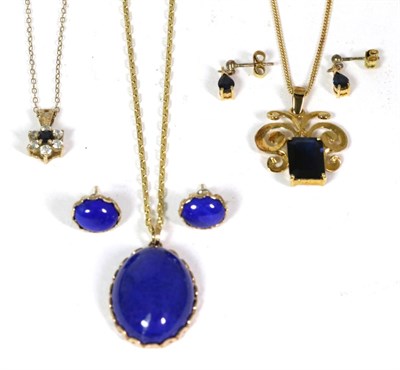 Lot 53 - A lapis lazuli pendant and earring suite, oval cabochon lapis lazuli in fancy claw settings,...