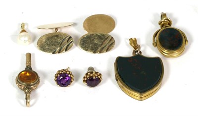Lot 54 - A bloodstone shield-shaped locket locket pendant, with chased decoration to the reverse,...