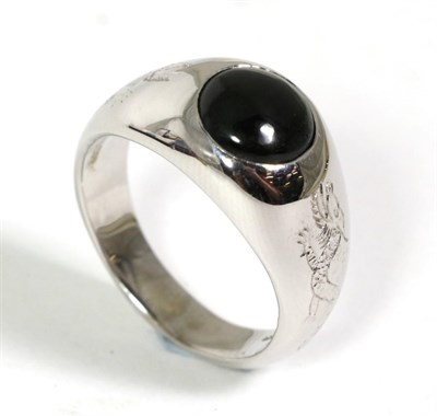 Lot 59 - An 18 carat white gold onyx signet ring, a round cabochon onyx inset to a tapering shank with...