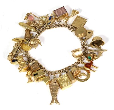 Lot 71 - A 9 carat gold curb link charm bracelet, with 32 charms, including an articulated fish, a sand...