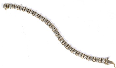 Lot 72 - A 9 carat two colour old diamond line bracelet, yellow gold links set with three round...