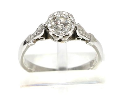 Lot 81 - A solitaire diamond ring, a round brilliant cut diamond in an illusion setting, to diamond-cut...