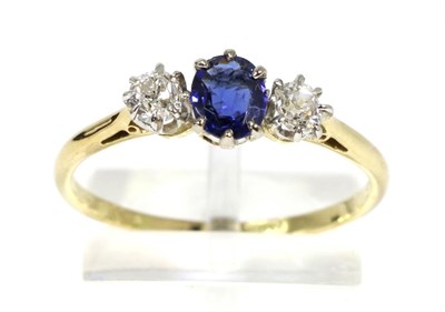 Lot 83 - A sapphire and diamond three stone ring, an oval cut sapphire in a claw setting, spaced by old...
