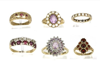 Lot 98 - A 9 carat gold garnet navette ring, set throughout with round cut garnets to scroll shoulders,...