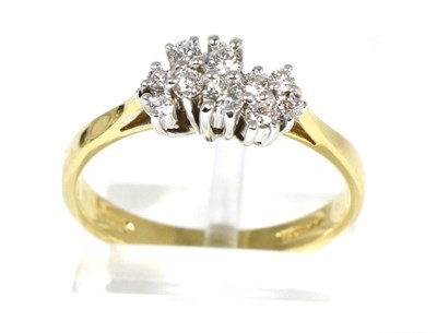 Lot 99 - An 18 carat gold diamond ring, an undulating cluster of vari-sized round brilliant cut diamonds...