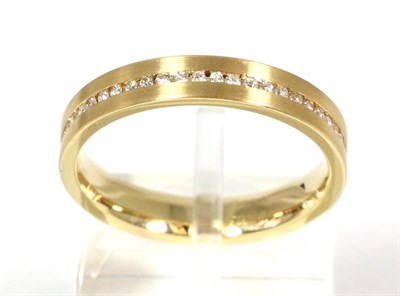 Lot 100 - An 18 carat gold eternity ring, channel set round brilliant cut diamonds to a brushed polished...