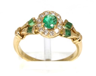 Lot 109 - An emerald and diamond cluster ring, an oval cut emerald in a claw setting, within a border of...