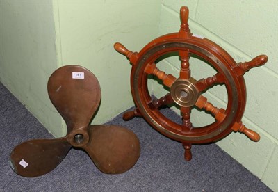 Lot 141 - A brass mounted teak ships wheel and bronze ship propeller