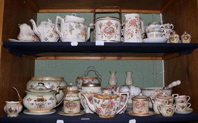 Lot 143 - Two shelves of Simon Fieldings Crown Devon pottery, including teapots, biscuit barrels etc