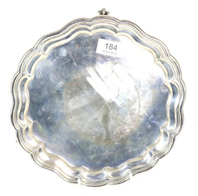 Lot 184 - A shaped circular silver salver, William Aitkin, Birmingham 1910, on three ball and claw...