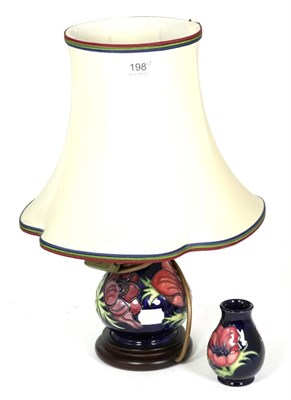 Lot 198 - A Moorcroft pottery Anemone pattern table lamp, 19cm high (excluding fitting); and a Moorcroft...