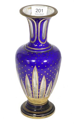 Lot 201 - A 19th century Bohemian glass vase, overlaid in deep blue and decorated with gilt stars and...