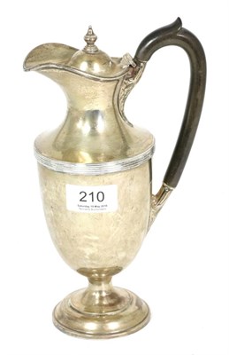 Lot 210 - A silver hot water jug, Henry Wilkinson & Co, London 1913, vase shaped with reeded band, 23cm high