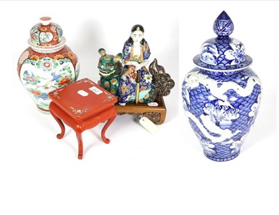Lot 212 - A Japanese Imari porcelain figure, Monju Bosatsu, wood stand; a Japanese porcelain jar and cover, a