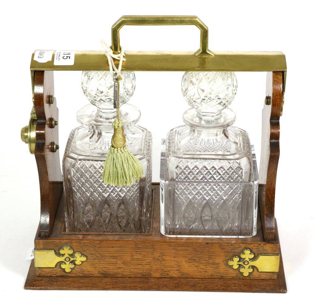 Lot 215 - An oak and brass two bottle tantalus