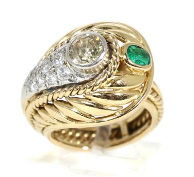 Lot 249 - An emerald and diamond crossover ring, an old cut diamond in a rubbed over setting within a...